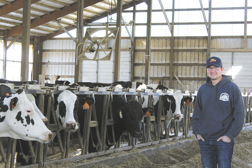 Matthew Tyler stands April 6 in his family’s freestall barn near Granton, Wisconsin. Tyler is the fifth generation of his family on the farm. He milks 120 cows with his parents.