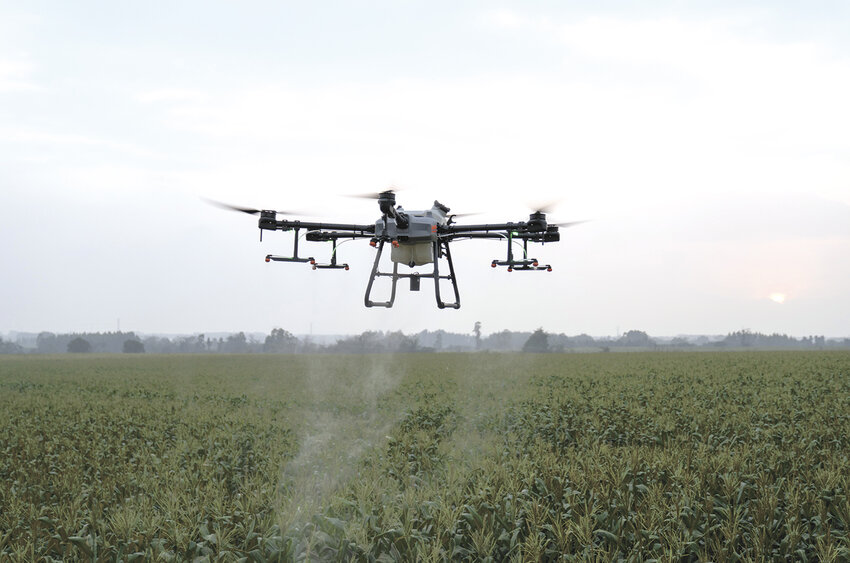 A 30-liter drone sprays corn in 2022. From cover crop aerial seeding and herbicide and fungicide application to doing test plots and crop scouting, drones have many uses in agriculture.