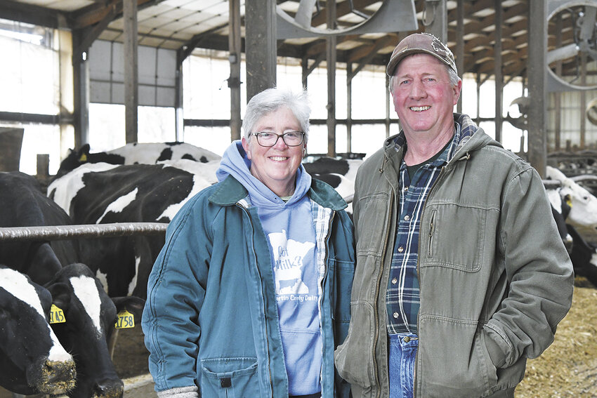 Lori and Bob Calkins smile in their freestall barn April 2 on their dairy farm near Blue Earth, Minnesota. The Calkins’ dairy farm has been in existence since Bob’s great-great-grandfather came in a covered wagon in November 1863.