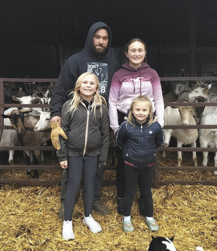 Kianna (front, from left) and Aleena; (back, from left) Tyler and Kendra Gerads gather Dec. 8, 2023, on their dairy farm near Albany, Minnesota. The three girls help with milking cows and goats in the evenings.