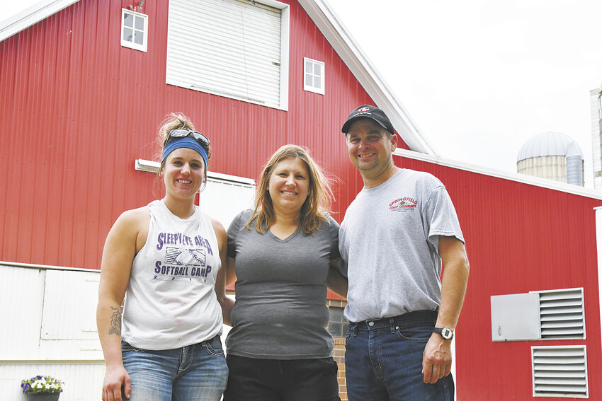 Emily Ludewig, Angie Tauer and David Tauer pause June 24 on the Tauer family’s dairy farm near Hanska, Minnesota. The Tauers milk 250 cows.