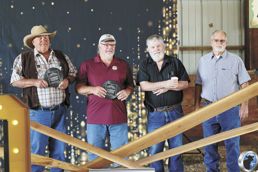 Merle Petersen (from left), Bruce Bolen, Ben Bolen and David Bolen accept their Legacy Awards at the North American Normande Association’s annual meetings and show Sept. 21 in Mineral Point, Wisconsin. The award is the first of its kind from NANA, recognizing members who played a vital role in bringing Normandes to the U.S. in the 1970s.