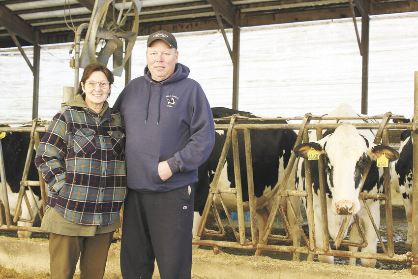 Pam Selz-Pralle (left) and Scott Pralle spend time in their freestall barn Feb. 20 at Selz-Pralle Dairy near Humbird, Wisconsin. The Pralles were honored as the 2024 Wisconsin Holstein Association’s Distinguished Holstein Breeders.