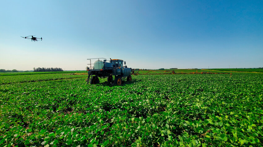 Brian Luck and his team fly a drone over a sprayer in a field near Madison, Wisconsin. Luck and his team worked with unmanned aerial vehicles to determine overall field health in different crops