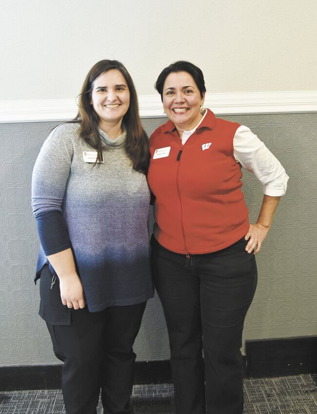 Stephanie Plaster (left) and Carolina Pizón gather Feb. 26 at Shady’s 55 Pub & Event Center in Paynesville, Minnesota. Plaster and Pizón presented during the ‘Milking Robots: are they the future?’ event.