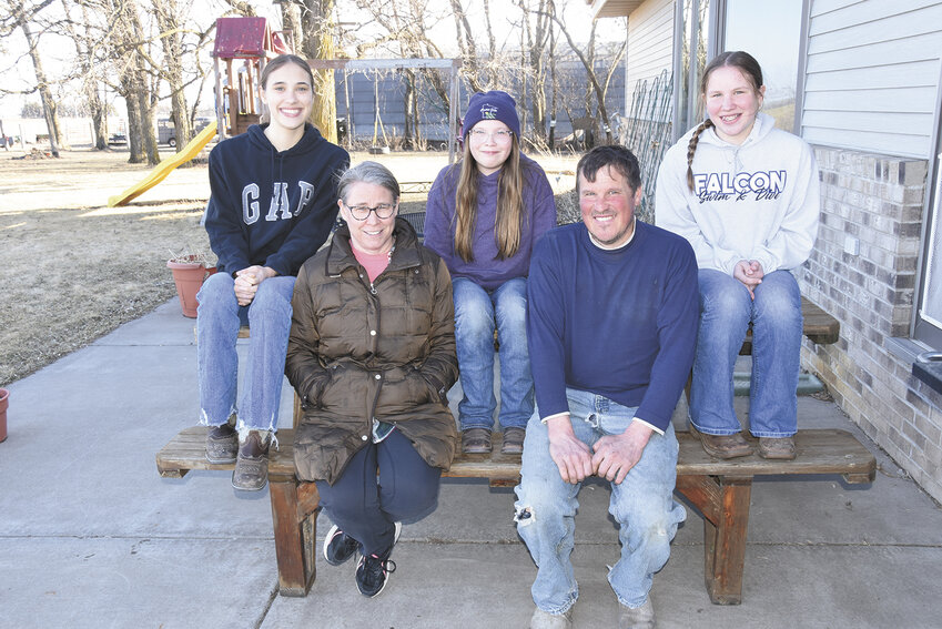 The Rahm family ­— Andrea (front, from left) and Brian; (back, from left) Maya, Malorie and Marnie — gathers March 17 at their farm near Foley, Minnesota. The Rahms milk 120 cows.