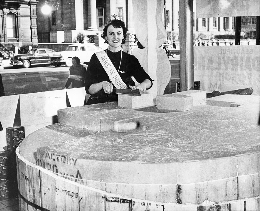 Mary McCabe Knight cuts cheese in 1954 as the seventh Alice in Dairyland. McCabe Knight hailed from Ladysmith, Wisconsin.