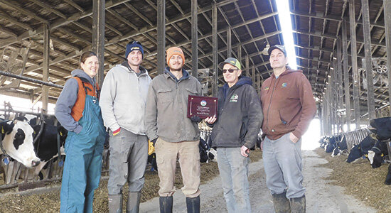The Borsts – (from left) Lindsey, Kevin, Kyle, Larry and Matt – are recognized with their National FARM award for animal care and antibiotic stewardship on their 230-cow dairy near Rochester, Minnesota. Lindsey and Kevin received the award Nov. 16 in Las Vegas, Nevada.  PHOTO BY KATE RECHTZIGEL