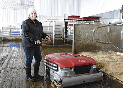 Ellen Dilly explains the manure collector system Nov. 24 at her family’s dairy near Ottertail, Minnesota. Dilly manages the herd. PHOTO BY JENNIFER COYNE