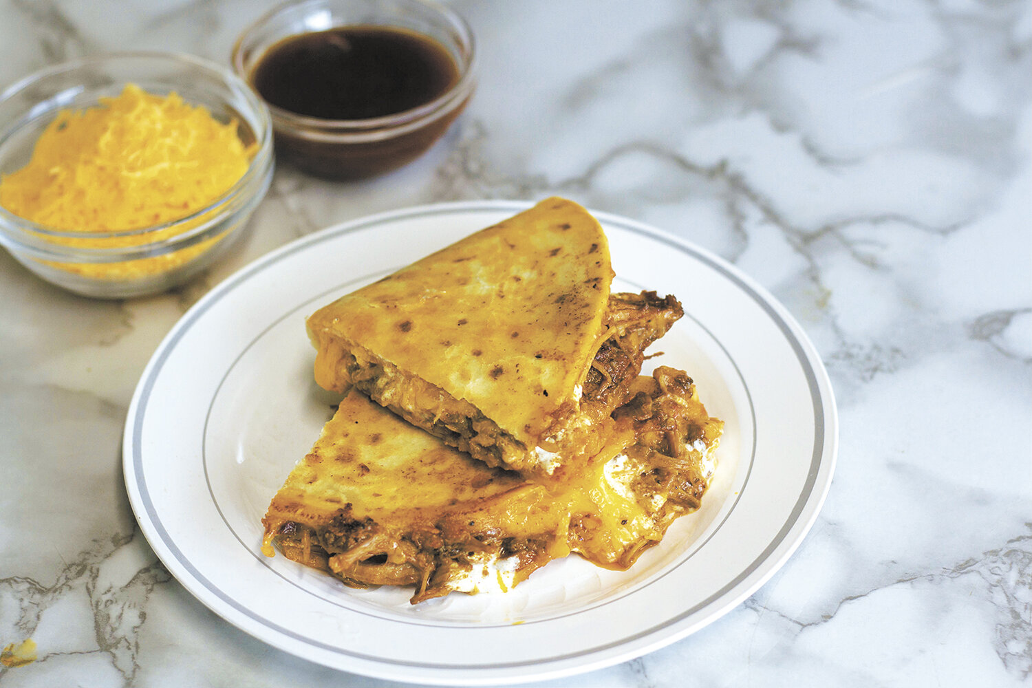 At BittyBean in Bismarck, North Dakota, one of the menu items is a house-smoked pulled pork quesadilla served with sour cream and cheddar cheese. BittyBean uses 30 pounds of various cheese every week.