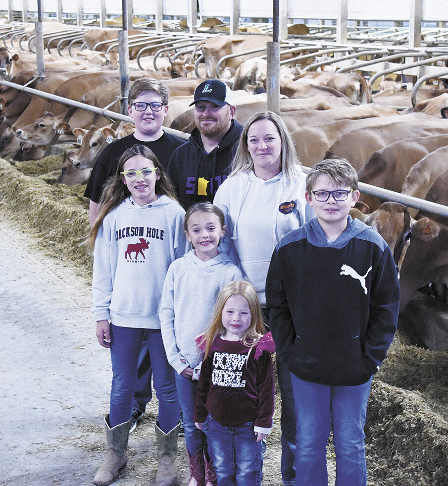 Adriana Swanson (front, from left), Aaliyah Swanson and Waylynn Wagner; (back, from left) Andon, Justin, Carissa and Owen Wagner stand in the freestall barn Oct. 18 at their farm near Forest City, Minnesota. The family milks 900 cows, raises chickens and grows crops.