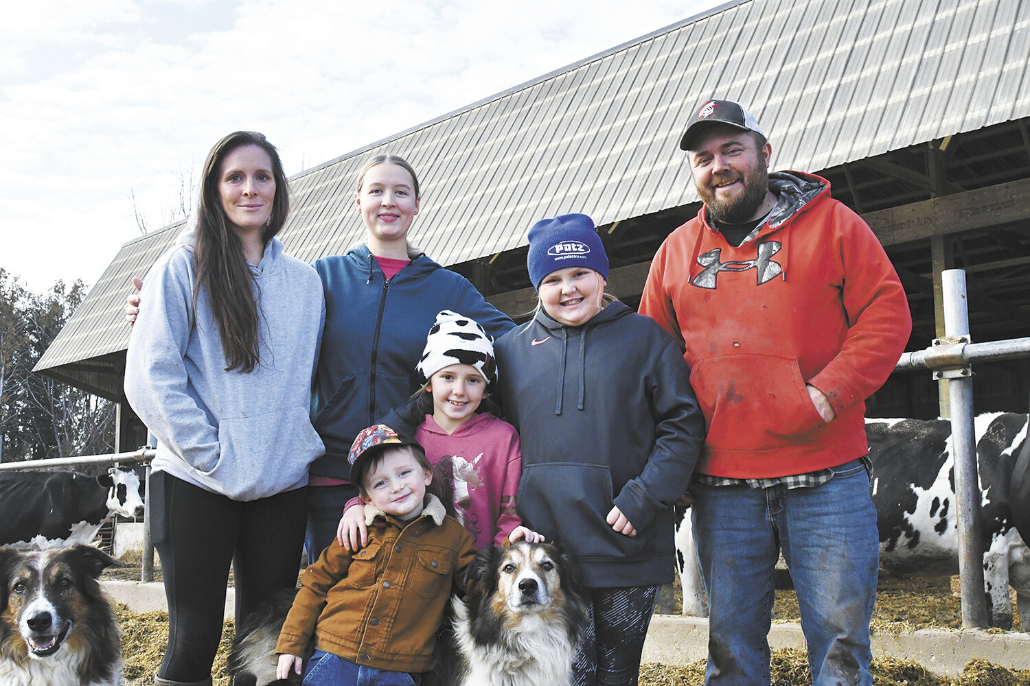 Ryan Eipers Jr. (front, from left) and Eva Eipers; (back, from left) Niki Eipers, Emily Willette, nanny, Olivia Eipers and Ryan Eipers stand by their freestall barn Nov. 2 on their dairy farm near Dodge Center, Minnesota. The Eiperses milk 144 cows and farm 300 acres.