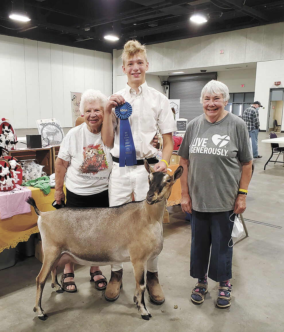 Marge Kitchen (from left), William Carlson and Karyl Dronen smile at the 2021 American Dairy Goat Association National Goat Show in Louisville, Kentucky. Kitchen and Dronen have been mentors for Carlson, and Carlson said some of his happiest memories from showing goats come from the funny things that happen when he is with Kitchen and Dronen.