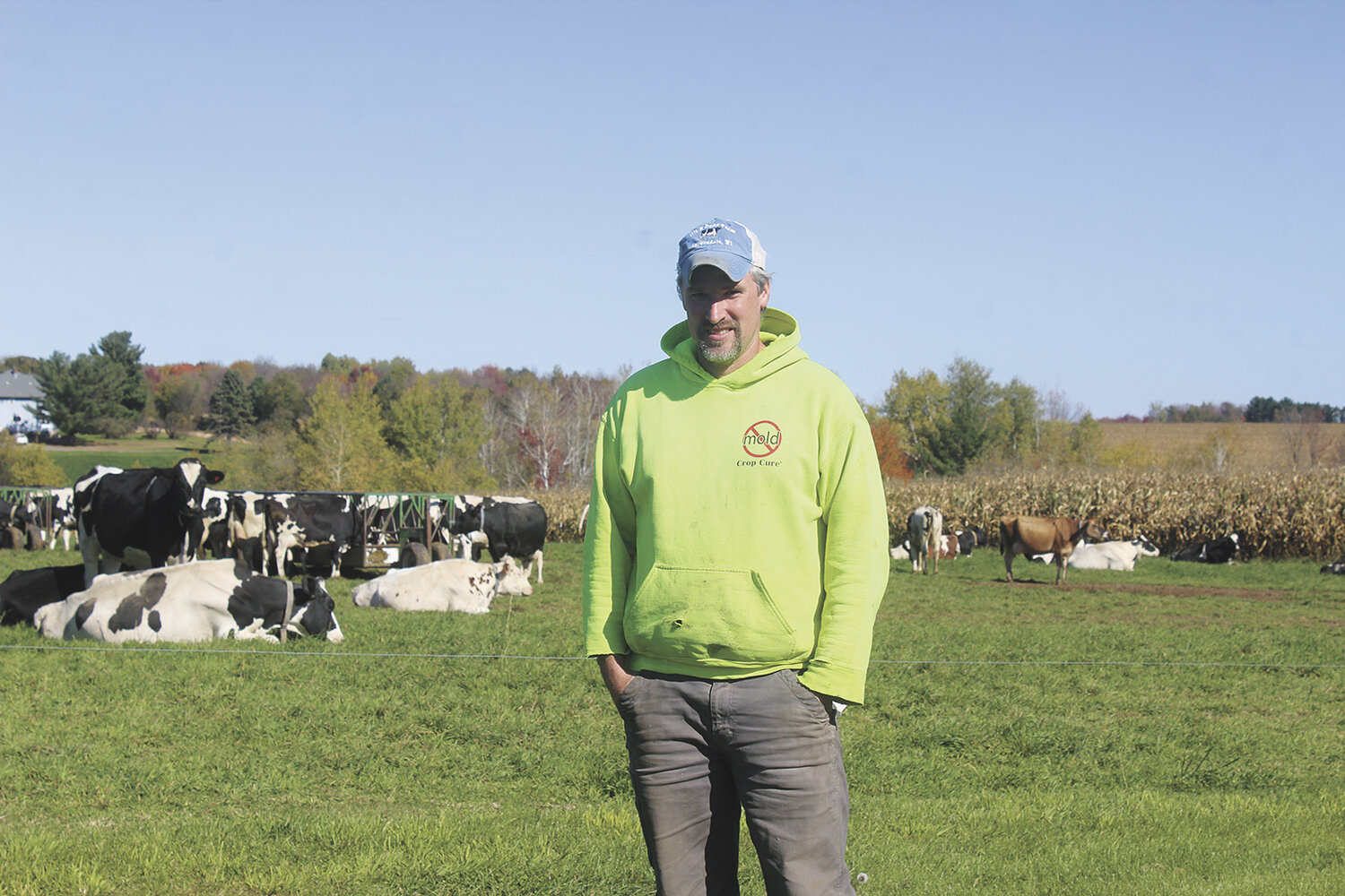 Steve Becker stands by his cows Oct. 16 on his dairy farm near Auburndale, Wisconsin. Becker broke his leg last fall on the morning he planned to take a day to attend World Dairy Expo in Madison, Wisconsin.