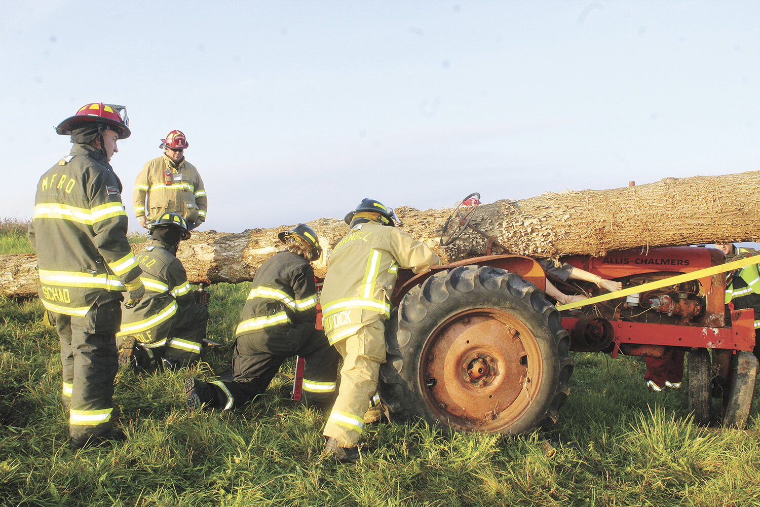 Emergency response personnel work to lift a tree off a victim in a rescue simulation at the Agricultural Response Training event held Oct. 21 at Heiman Holsteins in Marshfield, Wisconsin. The tree was lodged under the tractor’s steering wheel, further complicating the extrication.