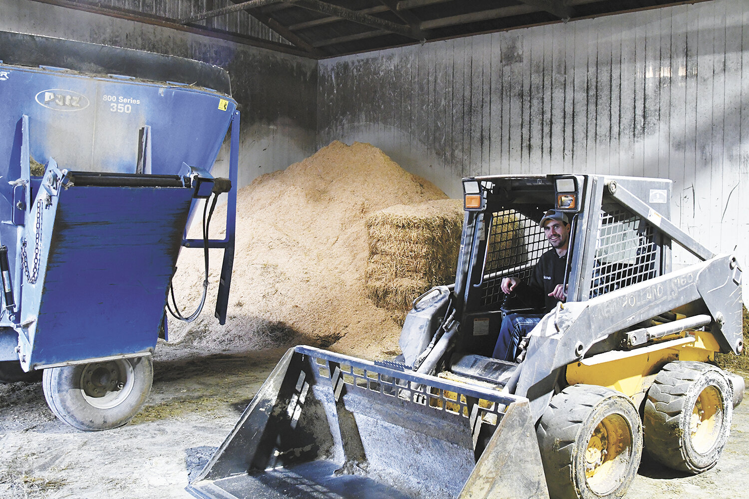 Marshall Friese sits in a skid loader Jan. 5 in the feed room at Rodash-View near Wanamingo, Minnesota. Friese was in this room loading the mixer with this skid loader when he leaned out to remove hay blocking his view of the scale. When the skid loader crept forward, he became crushed between the skid loader and the mixer.