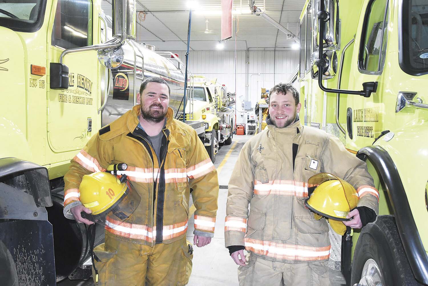Nick Hemmesch (left) and Sam Hopfer stand in the Lake Henry fire station Jan. 15 in Lake Henry, Minnesota. Both men are dairy farmers who also volunteer with the department.