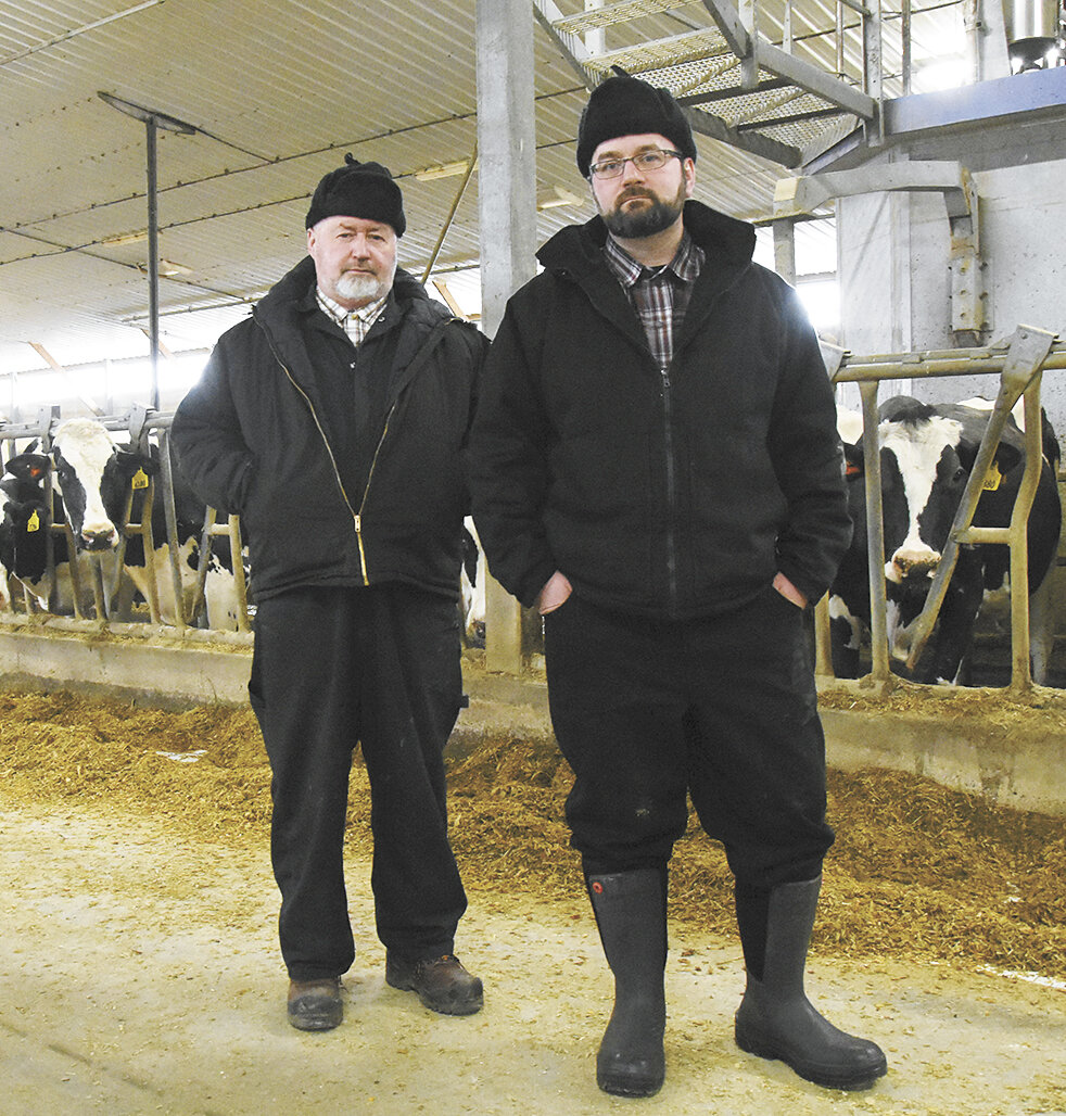John Jr. and Brian Waldner stand in their freestall barn Feb. 5 near Hawley, Minnesota. Blumenfeld Holsteins has a herd average of 30,476 pounds of milk with 1,327 pounds of fat and 1,017 pounds of protein.