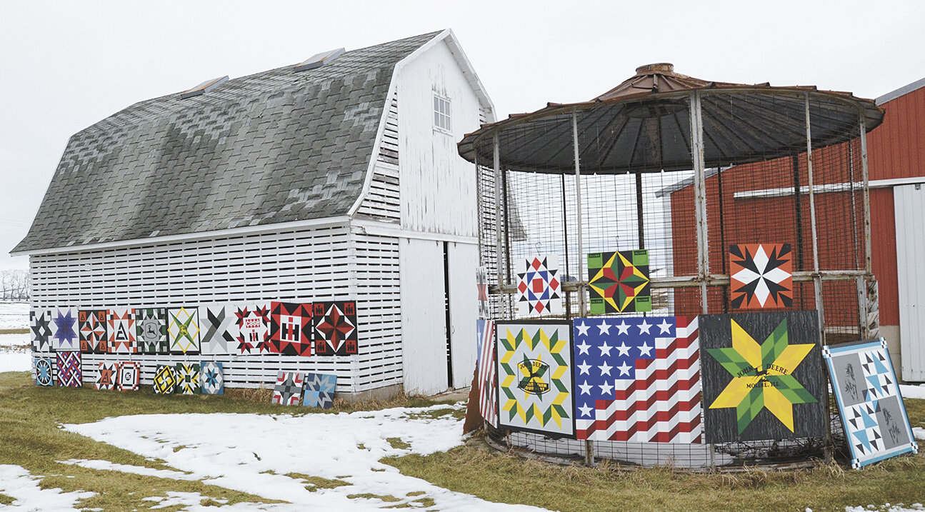 Barn quilts made by Emma Laufenberg are displayed on corn cribs Jan. 30 outside of her workshop near Waunakee, Wisconsin. Laufenberg enjoys creating custom designs.