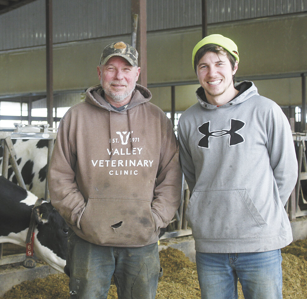 Bill (left) and Mack Drees stand in their robotic freestall barn Feb. 1 near Peshtigo, Wisconsin. Drees Dairy Farm LLC is home to 250 cows that are milked with four robotic milking units.