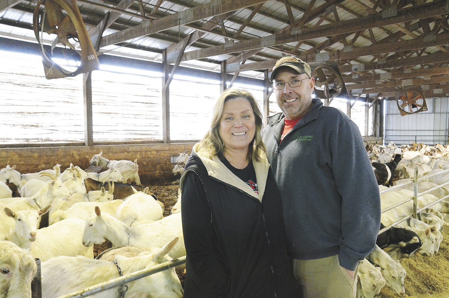 Kim and Aaron Dooley stand in a barn Jan. 30 on their farm, O’Dools Dairy Goats, near Orfordville, Wisconsin. The Dooleys milk 500 goats and farm 180 acres.
