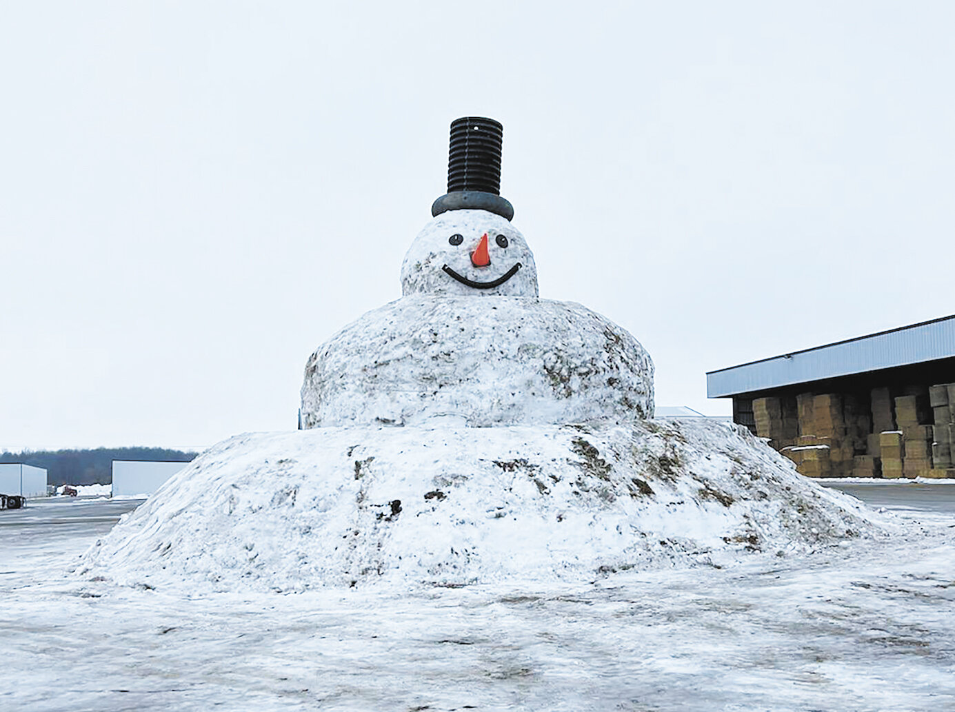 A decorated snowman sits on the Wiese Brothers Farm near Greenleaf, Wisconsin. The snowman measures 32 feet tall and 140 feet around at the base. This is the second year the Wiese family has built a giant snowman on their farm.