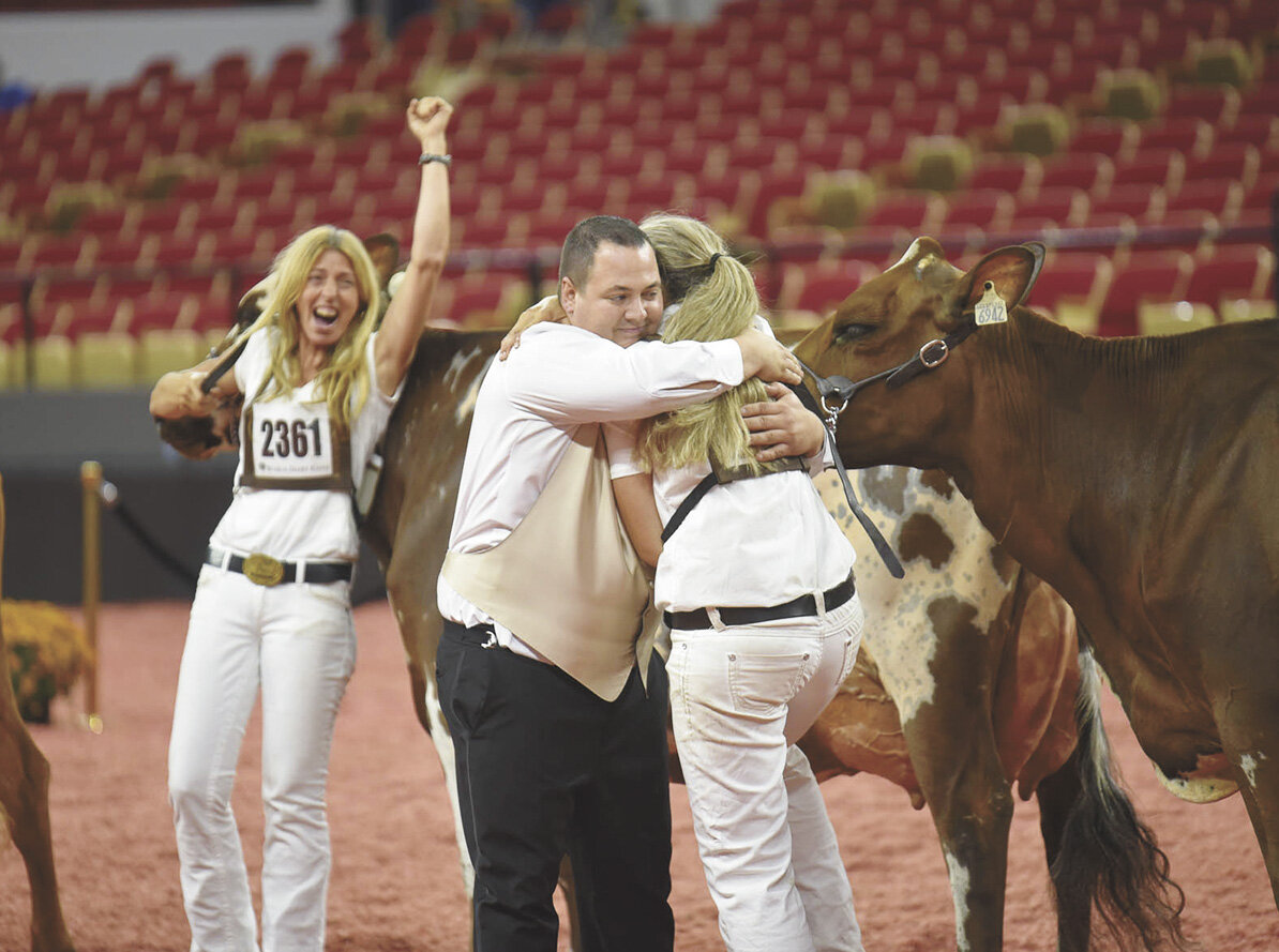 Vicky Foley (left) watches as judge Brandon Ferry congratulates her sister, Bianca Foley, for exhibiting their homebred cows, who were named grand and reserve grand champion of the International Ayrshire Show Oct. 1 at World Dairy Expo in Madison, Wisconsin. The Foleys, from Piopolis, Quebec, exhibited two cows at Expo — grand champion Vieux Village Gentleman Joy and reserve grand Champion Vieux Village G Montana.