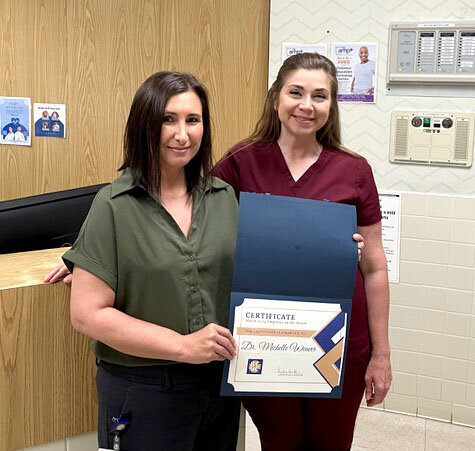 BCMC CEO/CFO Leslie Huitt presents
Dr. Michelle Weaver with Employee of the Month Award