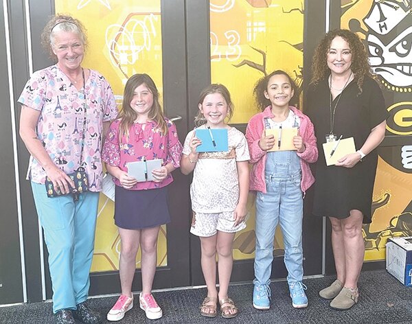 Pictured from left to right are Val Questel, Fiona Hebner (2nd grade), Ruby Hill (1st grade), Hanna Mederos (3rd grade), and art teacher, Christeena Herring.