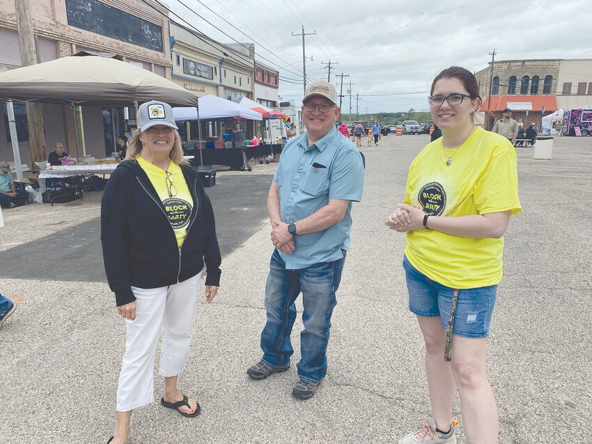 From left to right, Gatesville Eclipse Coordinator Cheri Shepherd, Mayor Gary Chumley, and Director of the Gatesville Public Library, Shea Harp, at the Block (Out the Sun) Party on the Sunday before the eclipse.
