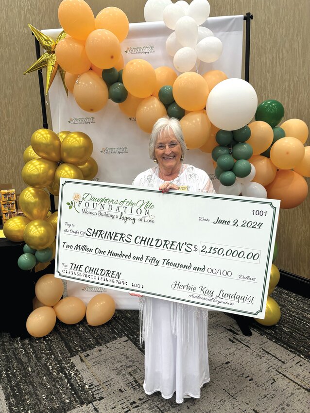 Sherry Hopson poses with a $2 million check to be donated to the Shriners Children's organization from Daughters of the Nile.