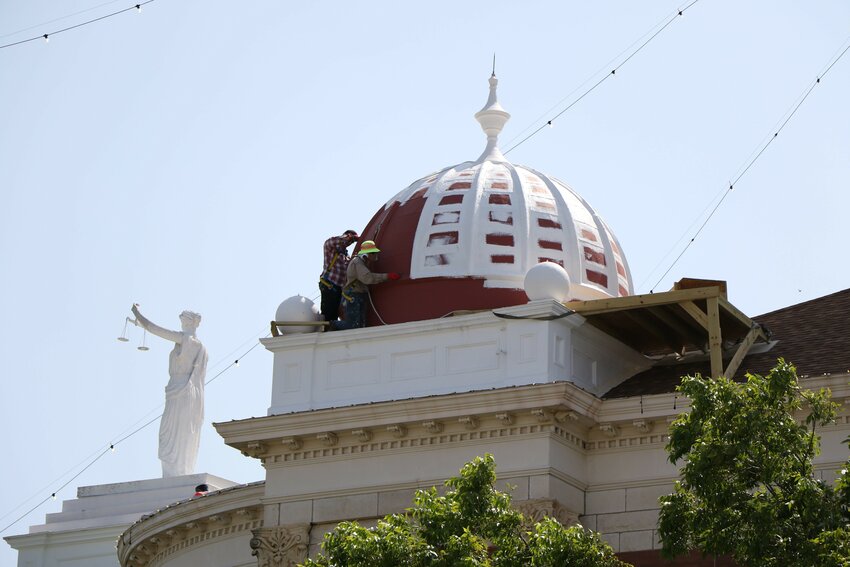 Workers for A*R*C*Hitexture re-applying another coat of a rubber-based sealant to the horizontal and vertical seals of the northwest dome on the courthouse.