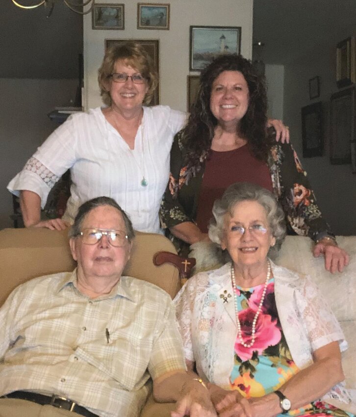 Dale and Laura White seated with their daughters Michelle (left) and Suzanne.