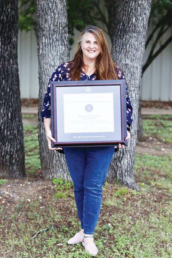 Gatesville City Secretary, Holly Owens, is shown with the Municipal Clerk's Office Achievement of Excellence Award, which was presented to the City of Gatesville.