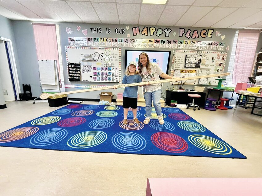 Gatesville Primary student Jeremiah Tatum and kindergarten teacher Kendra Pruitt are shown with the 12-foot-long spoon.