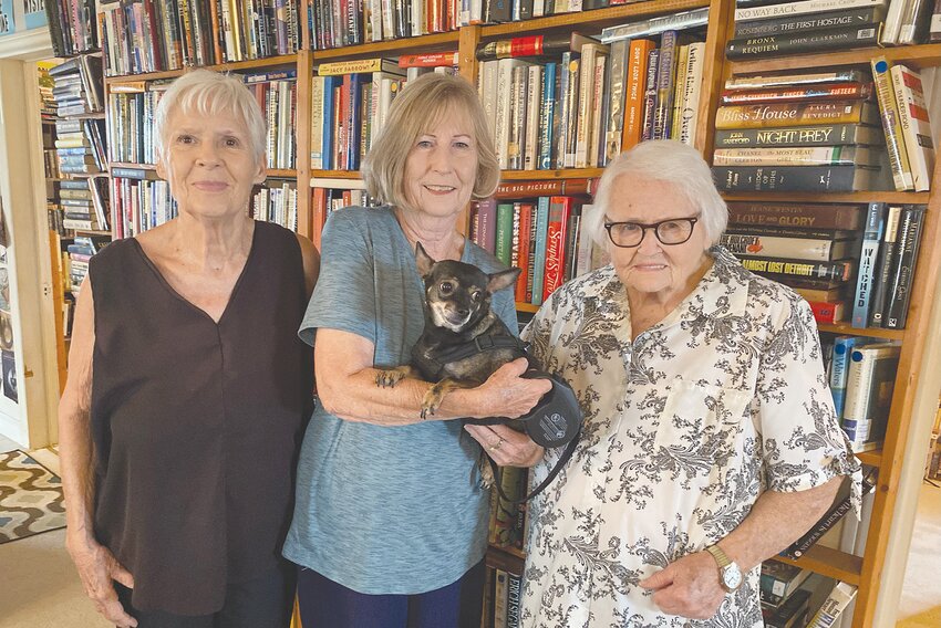 Pictured left to right, Linda Ray, Corlisa Cunningham, and Kay Pruett, who are the backbone of the Pearl Cottage Bookstore, which houses well over 6,000 used books. Corlisa is seen holding the bookstore’s mascot, Mimi.