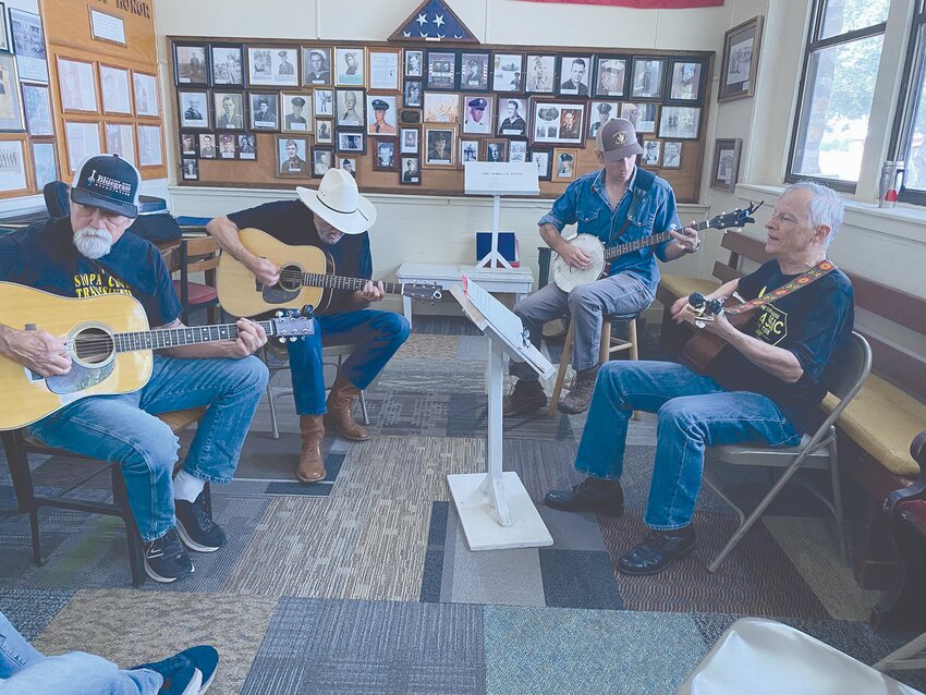 Musicians jam together in one of the practice rooms at the Pearl Bluegrass event.