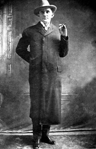 Deacon Jim Miller wearing his familiar frock coat under which he used to conceal a steel plate to shield himself from bullets.