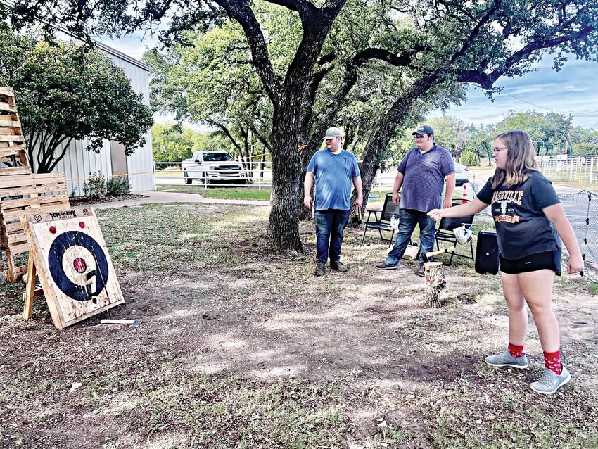 Locals are pictured while participating in last year’s axe throwing contest.