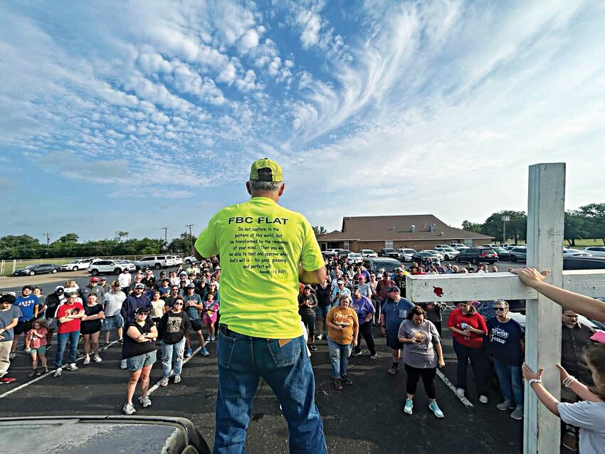Founder of the Good Friday Cross Walk, Carlos Webb, is pictured speaking to community members before the walk at the First Methodist Church.