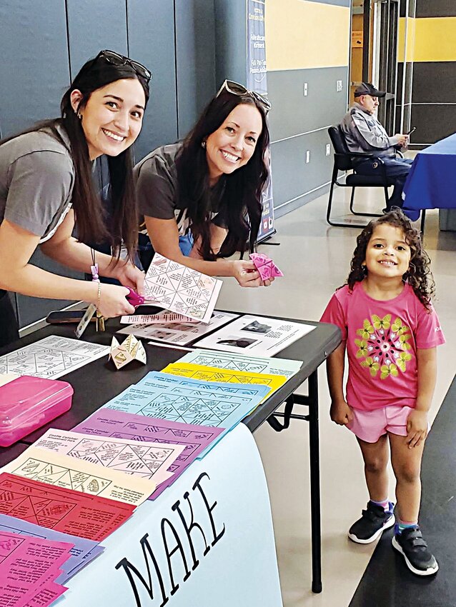 Paraprofessional Areisy Chacon (left) and Kari Patterson, ESL teacher, are pictured with a student during Gatesville Elementary School’s Spanish Community Resource Night.