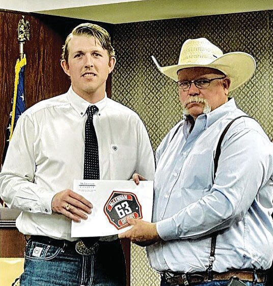Luke Gregory is pictured receiving his certification from his father Philip.