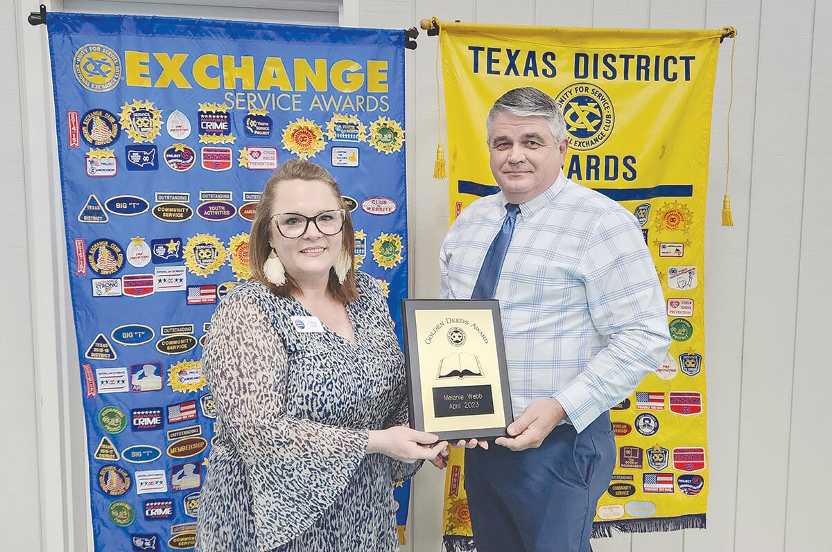 Assistant Superintendent of Administrative Services Scott Harper presented the Exchange Club’s “Book of Golden Deeds” award to Melanie Webb, the founder of Righteous Roots.