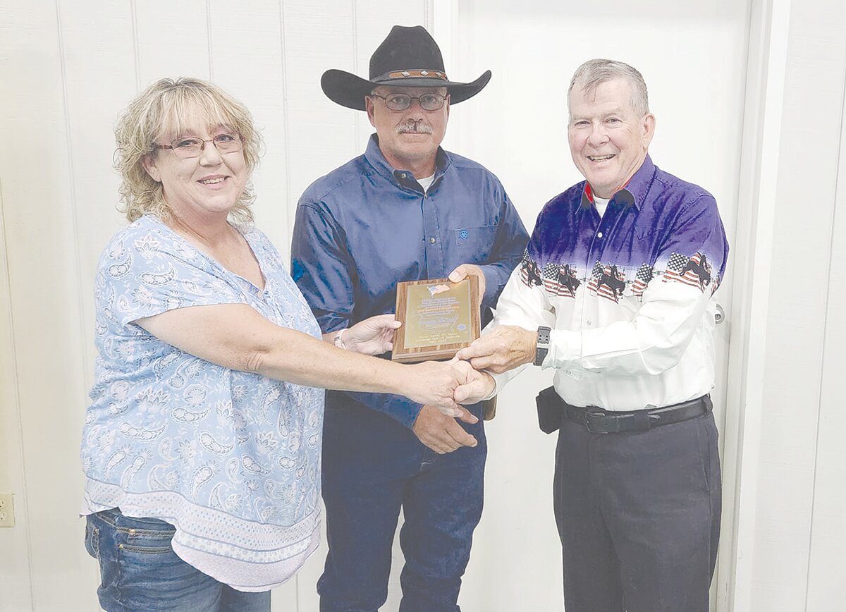Alan Mathis, right, presented the “Proudly We Hail” award to the managers of the Hidden Valley RV Getaway to Anishia Bayer and Michael Bayer.