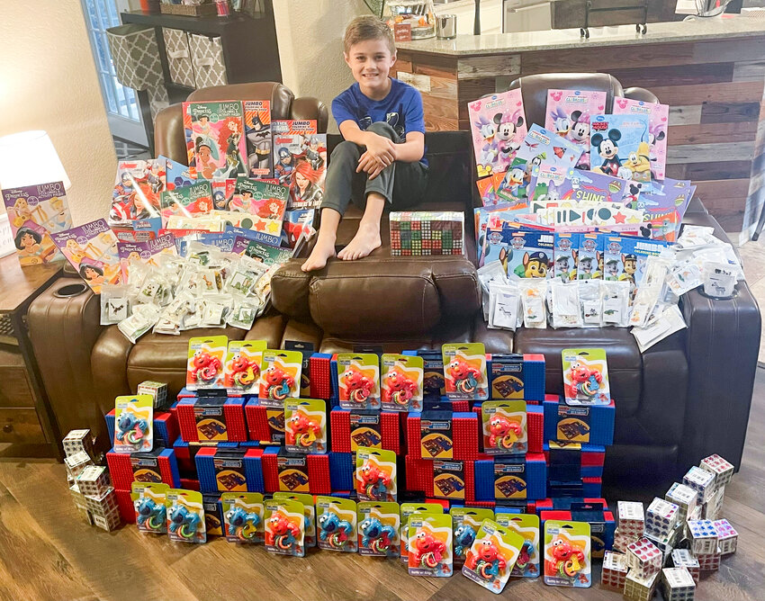 Pictured is Cameron Taylor with the toys he bought for patients at Cooks Children's Hospital after raising money by running his own lemonade stand.