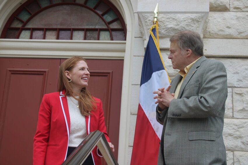 State Rep. Shelby Slawson speaks to Senator Brian Birdwell during the grand opening and ribbon cutting celebration of her new district office April 10.