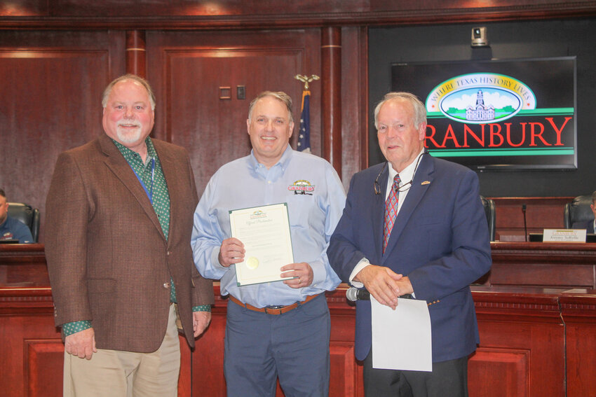 City Manager Chris Coffman, left, and Mayor Jim Jarratt, right, present a proclamation designating May 6-10 as Economic Development Week during a Granbury City Council Meeting April 16. Economic Development Director Lance LaCour, middle, was also recognized by Jarratt and Coffman.