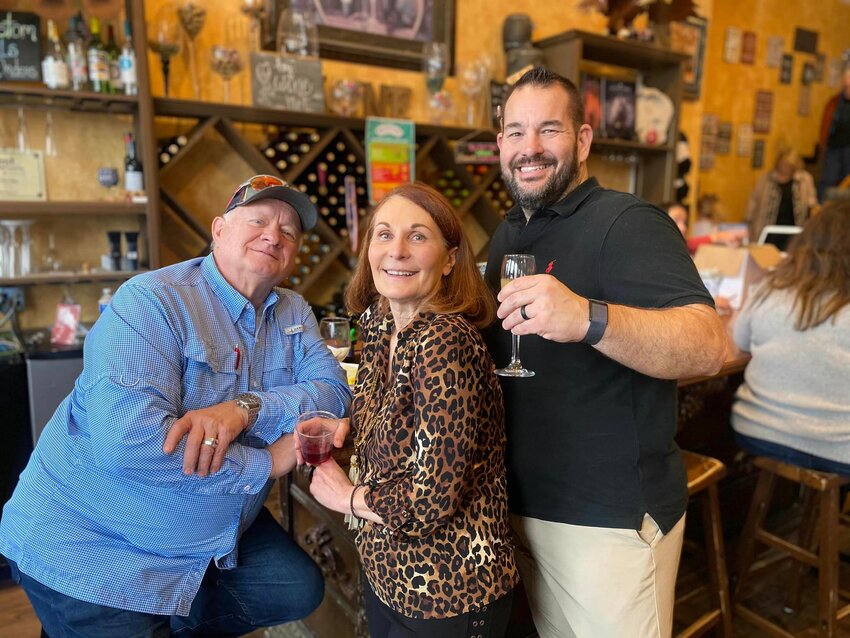 From left: Dr. Tony Hedges, Diane Hedges, and Joshua Winters enjoy the atmosphere at D’Vine Wine in Granbury.