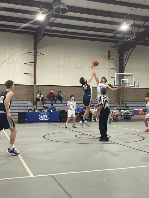 Freshman Tyler Struickmans contesting the opening jump ball against Jesus Chapel Chargers.