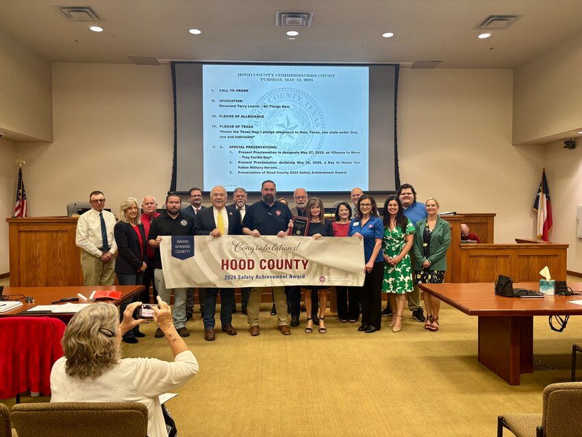 Hood County faculty gather around the banner that announces the county as a winner of the 2024 Safety Achievement Award.
